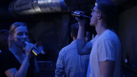 Handheld shot of stylish guy and girl dance together at their favourite club 스톡 동영상 114847799