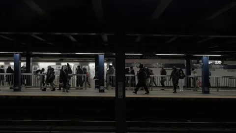 Handheld shot of a subway train arriving at Broadway Junction Stock Footage 262608361