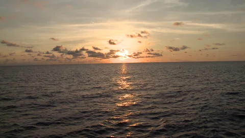 Handheld shot of the sunset over the ocean Stock Footage 310539855