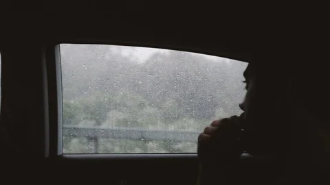 Handheld shot of thoughtful man looking outside while travelling in a car Stock Footage 122396244