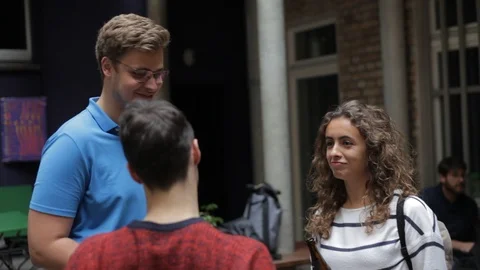 Handheld shot of three friends talking enjoying the event Stock Footage 114847140