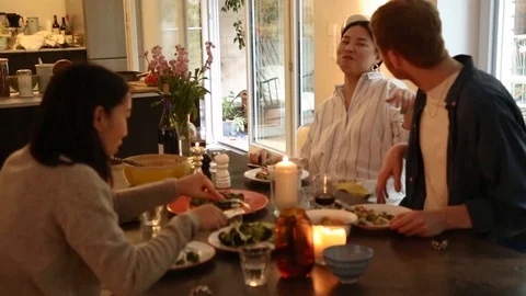 Handheld shot of three people talking and having dinner Stock-Footage 114846682
