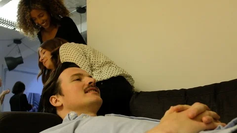 Handheld shot of three young man and women smiling and talking in office Video stock 120431912