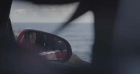 Handheld shot through back seat of professional surfer sitting in passenger seat Video stock 160114845