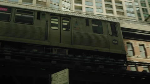 Handheld shot of a train passing by in downtown Chicago Stock Footage 243675204