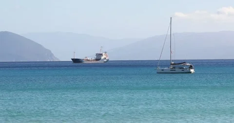 Handheld shot of two different ships anchored near Zakynthos. Clear blue water i Stock Footage 220682035