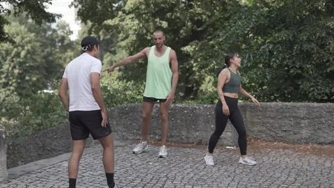 Handheld shot of two fit people jogging up steps and doing push ups Stock Footage 114875111