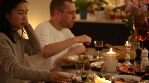 Handheld shot of two friends having dinner and a man pouring water in glasses Stock Footage 114846674