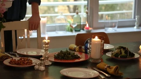 Handheld shot of two friends standing beside dining table at home Video stock 114846640