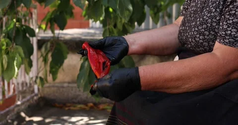 Handheld shot of two hands with black gloves while cleaning the burnt skin of a Stock Footage 207719480