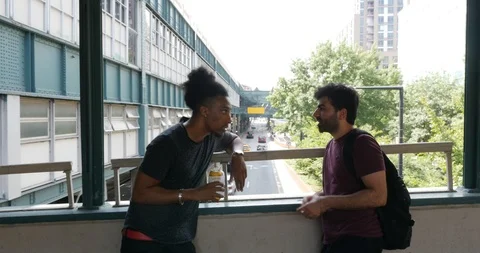 Handheld shot of two man talking by window in the city Stock Footage 120149750