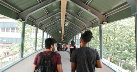 Handheld shot of two man walking on subway station Stock Footage 120150036