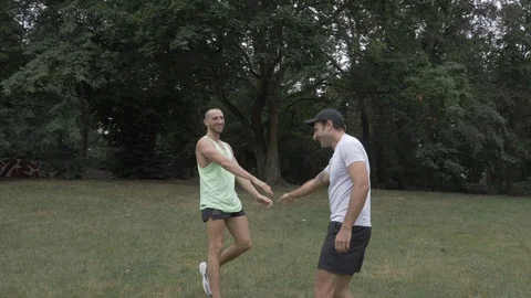 Handheld shot of two men enjoying leisure time after doing push-ups Stock-Footage 114843143