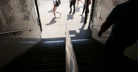 Handheld shot of two men walking up stairs Stock Footage 120150141