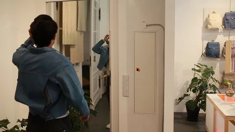 Handheld shot of two people trying on things at the store Stock Footage 114886063