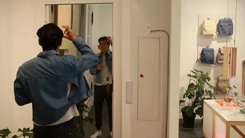 Handheld shot of two people trying on things at the store Stock-Footage 114886067