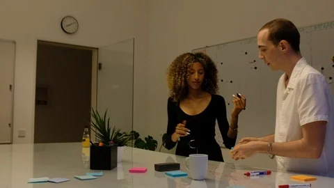 Handheld shot of two people working on project 스톡 동영상 120419072