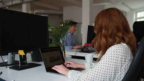 Handheld shot of two people working at office Video stock 120426333
