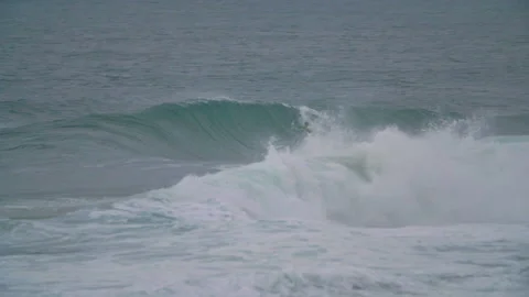 Handheld shot of two pro surfers riding jet ski and surfing on surfboard Stock Footage 158651717