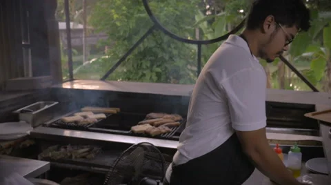 Handheld shot of two restaurant workers preparing food at a counter Video stock 58751517