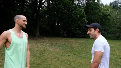 Handheld shot of two young men in sportswear give high fives to each other Stock Footage 114879650
