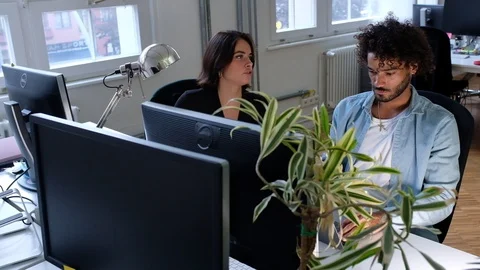 Handheld shot of two young people working on laptop Video stock 120422641