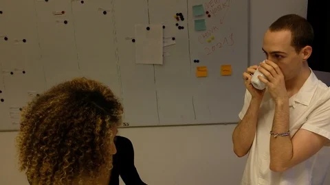 Handheld shot of two young people working on project in office Video stock 120428367