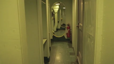 Handheld shot walking down Naval ship corridor Stock Footage 252350886
