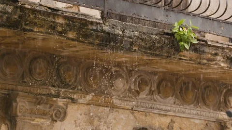 Handheld shot of water dripping down from roof and balcony, rainy season, Cuba Stock Footage 141664573