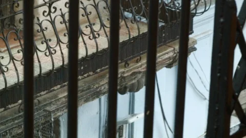 Handheld shot of water dripping down from roof and balcony, rainy season, Cuba Stock Footage 142212274