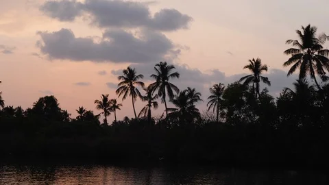 Handheld shot from water surface of silhouettes with sunset, Shambhavi river Stock Footage 145044151