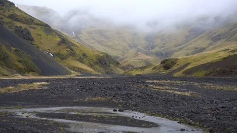 Handheld shot of waterfall from distance Stock Footage 118654610