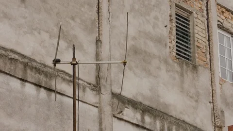 Handheld shot of weathered balcony with window and door, rainy season, Cuba Stock Footage 141665723