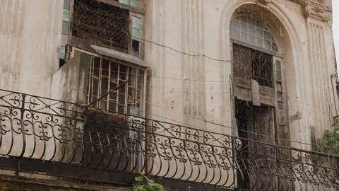 Handheld shot of weathered balcony with window and door, rainy season, Cuba Stock Footage 142212478