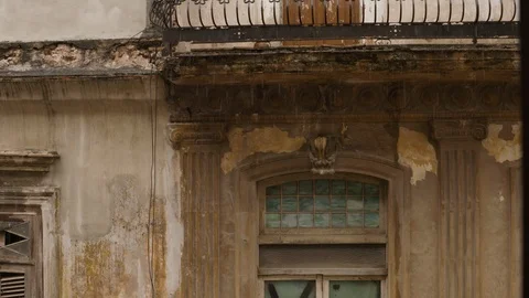 Handheld shot of weathered balcony with window and door, rainy season, Cuba Stock Footage 142212609