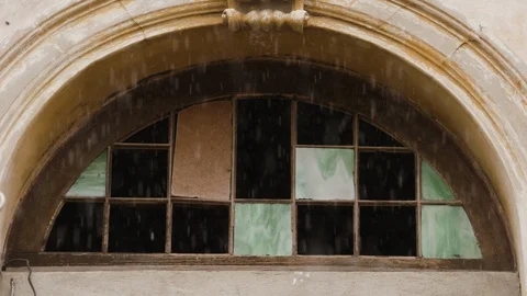 Handheld shot of weathered window with broken glass during rainy season, Cuba Stock Footage 141665980