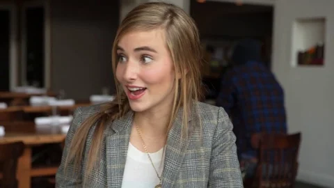 Handheld shot of woman talking with female friend in restaurant Stock Footage