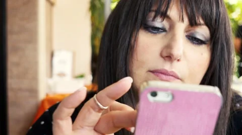 Handheld shot of woman using smart phone at restaurant. Shot in 4K Stock Footage 49709145