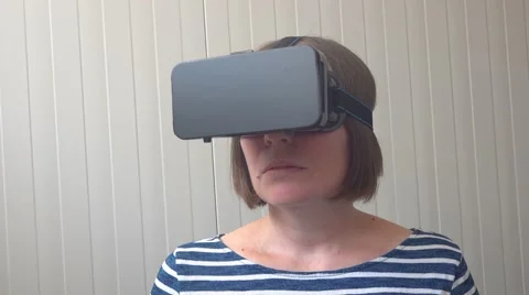Handheld shot of woman with VR headset goggles Stock Footage
