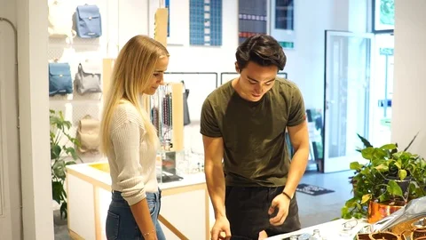 Handheld shot of young couple browsing items in shop Stock Footage 114883927
