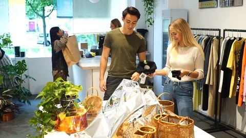 Handheld shot of young couple browsing for items in shop Stock-Footage 114883975