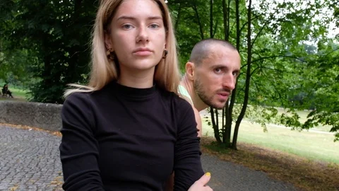 Handheld shot of young couple staring at camera confidently in park Stock-Footage 120431402