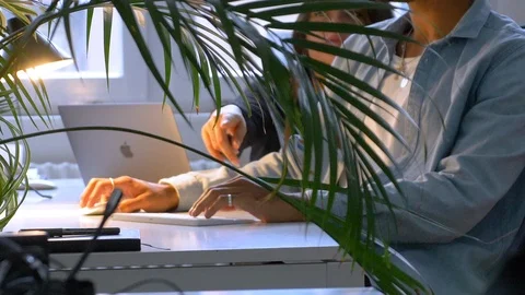 Handheld shot of young executives passing planner to his colleague Video stock 114872888