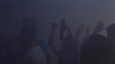 Handheld shot of young friends dancing in a group in a night club Stock Footage 114877604