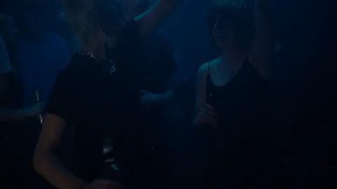 Handheld shot of young friends dancing in nightclub Stock Footage 114877702