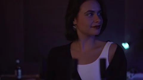 Handheld shot of young lady dancing behind club counter Stock Footage 114876574