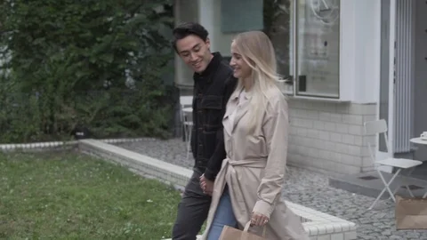 Handheld shot of young man and young woman walking with holding hands Stock Footage 114875677