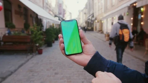 Handheld shot of young man browsing mobile application on vertical smartphone Stock Footage 117429128