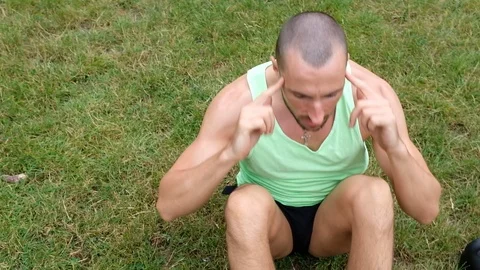 Handheld shot of young man doing sit-ups on lawn Stock Footage 120422155