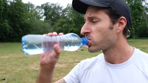 Handheld shot of young man drinking water Video stock 120423014
